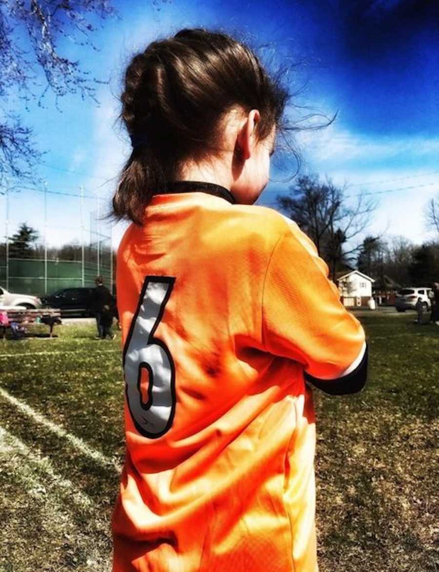 young girl in soccer field