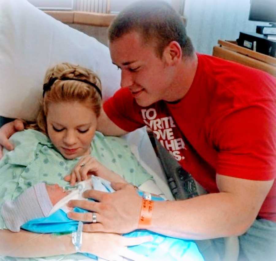 Young married couple take photo with their newborn son after giving birth