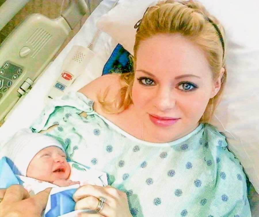 First time mom takes selfie while holding her newborn son after giving birth to him