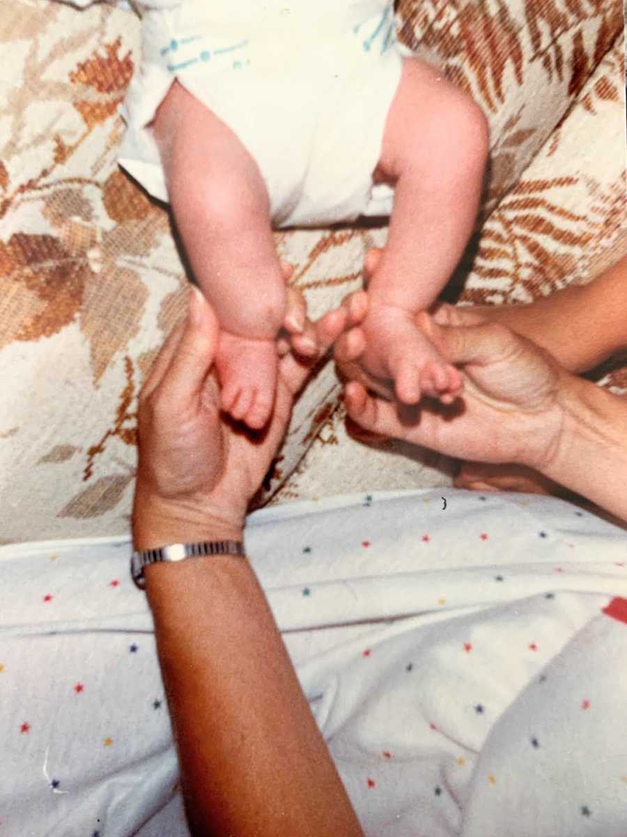 baby's feet in parent's hands