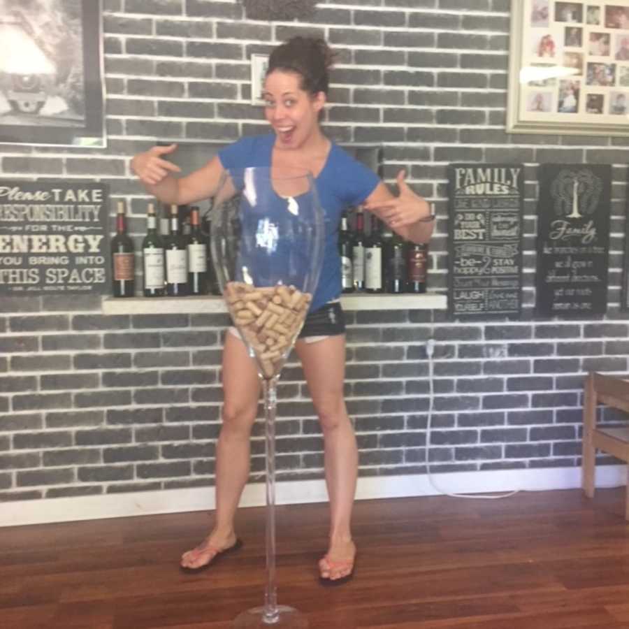 woman standing with gigantic wine glass