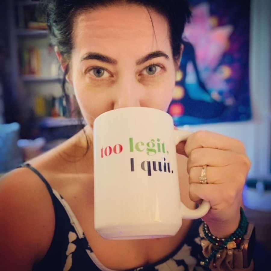 woman holding "too legit I quit" mug