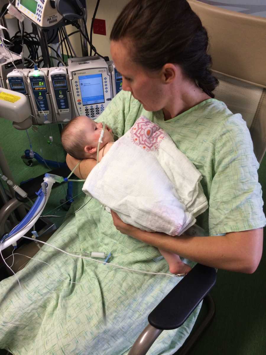 woman holding her baby with tubes