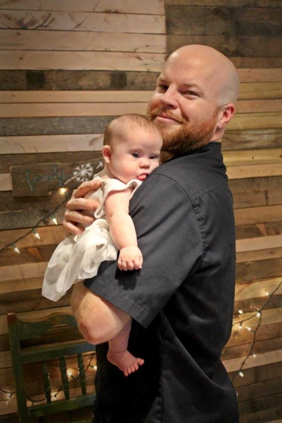 dad holding his baby girl