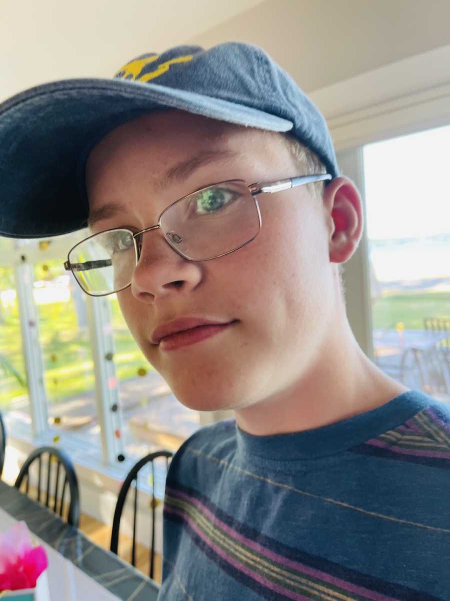 teenage boy with glasses and a hat