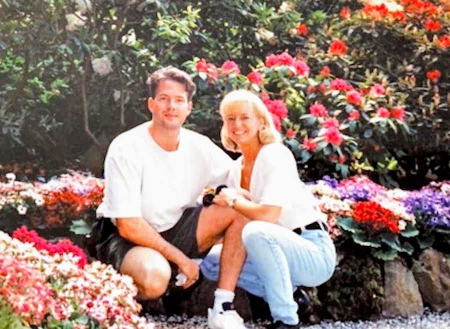 couple surrounded by flowers