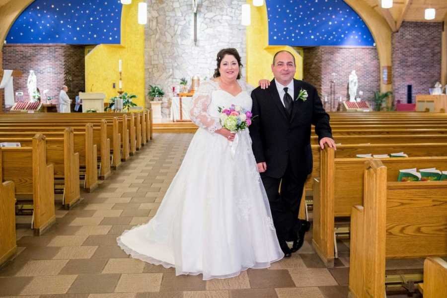 Couple who met on Facebook take a photo together in the church where they had their wedding ceremony