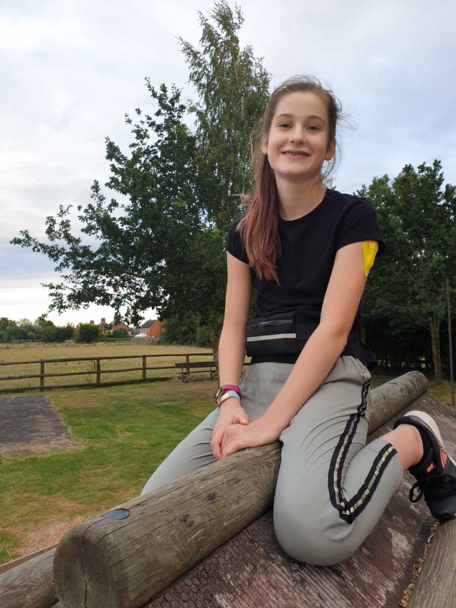 girl sitting on a fence