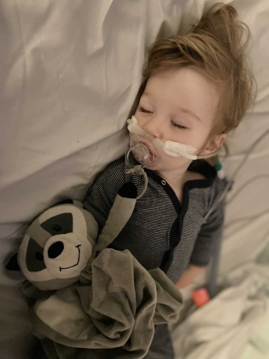 young boy with breathing tube