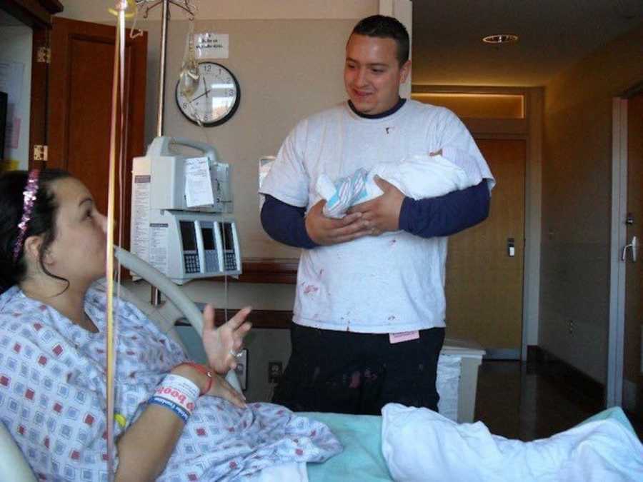 brother holding his sister's baby