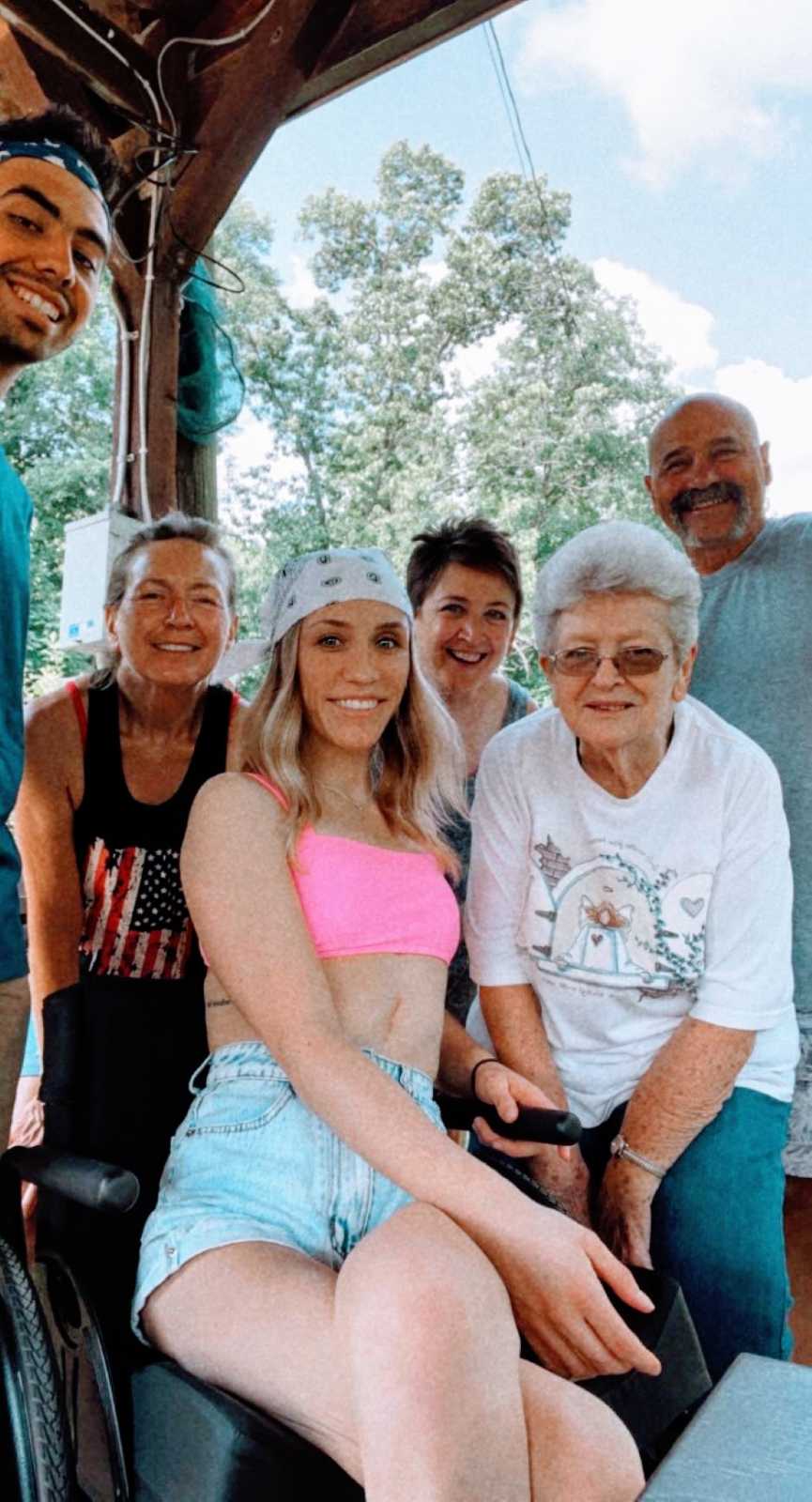 Woman wheelchair bound after tragic car accident takes a photo with her family