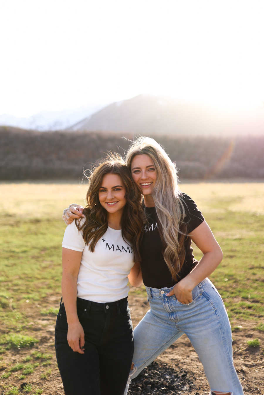 mom and stepmom posing together