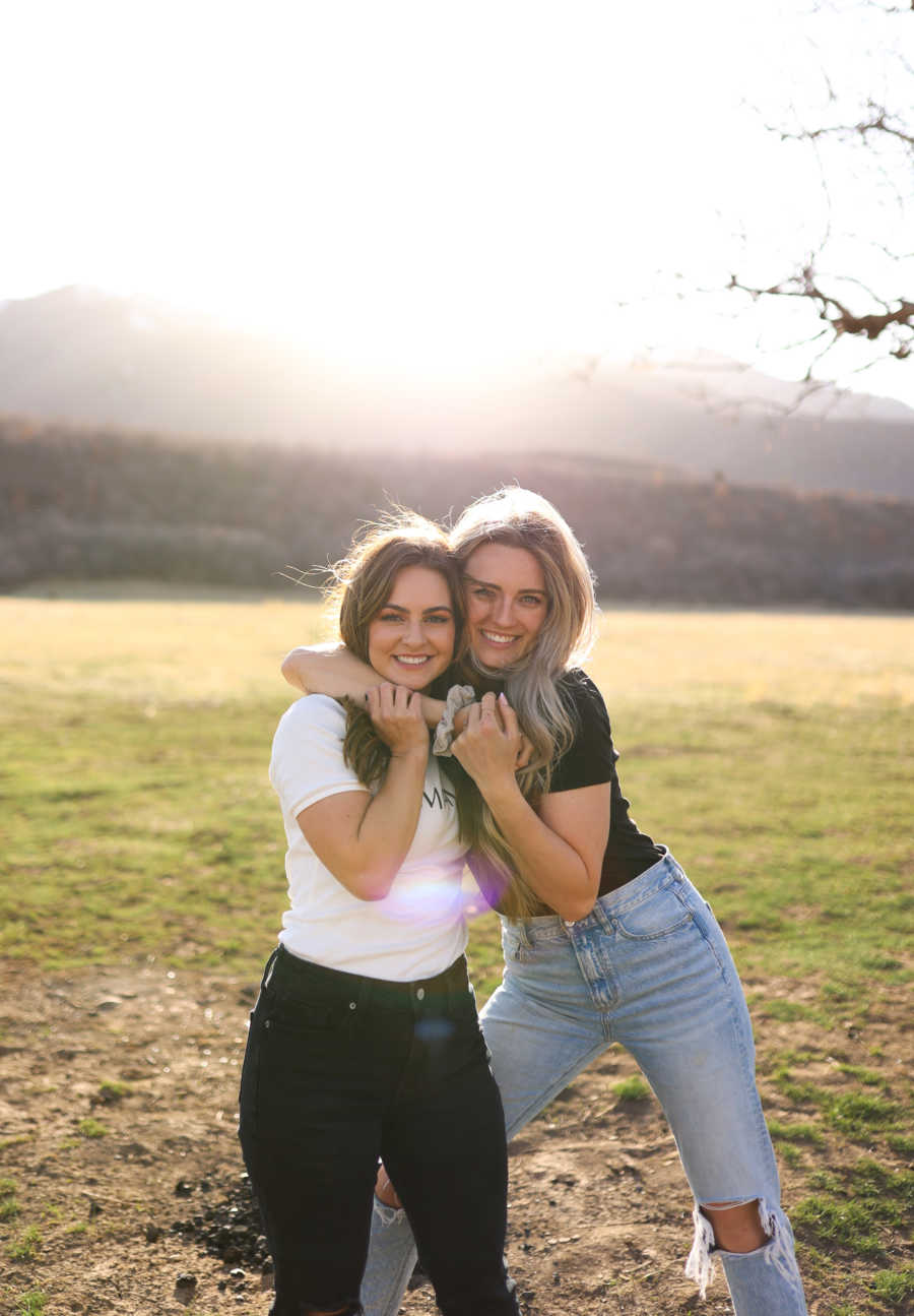 mom and stepmom hugging