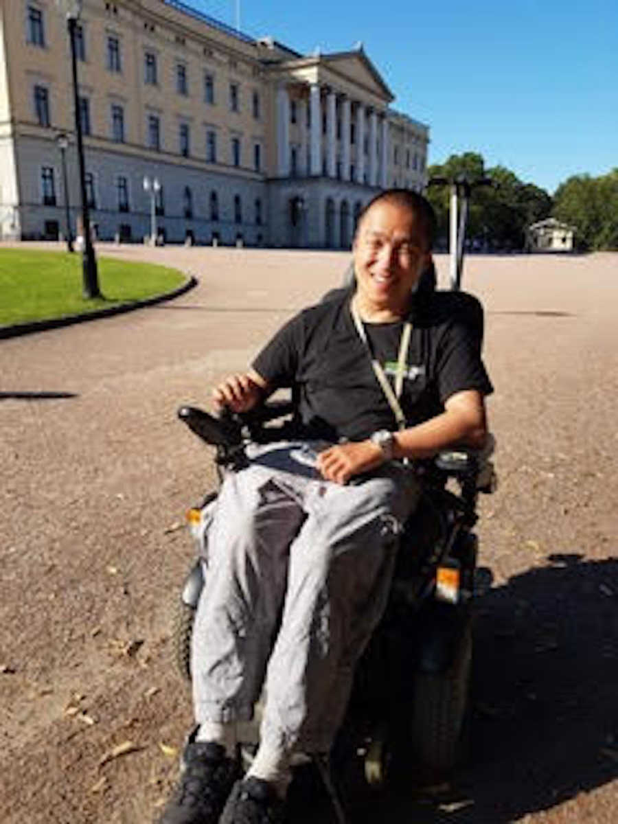 young man in wheelchair smiling