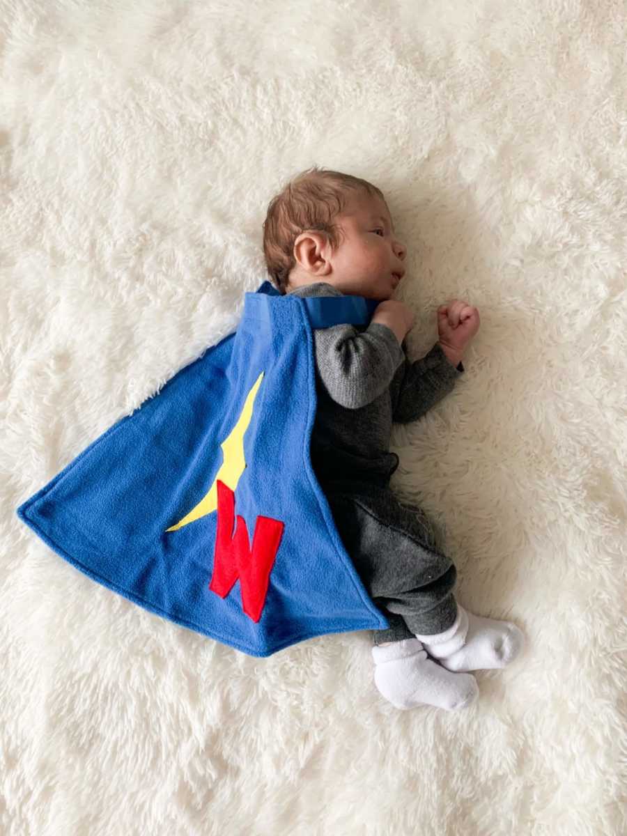 A little boy dressed like a superhero