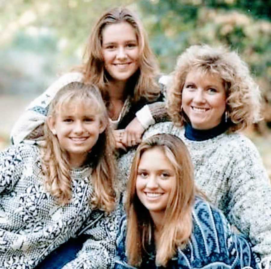 A mother sits with her three daughters