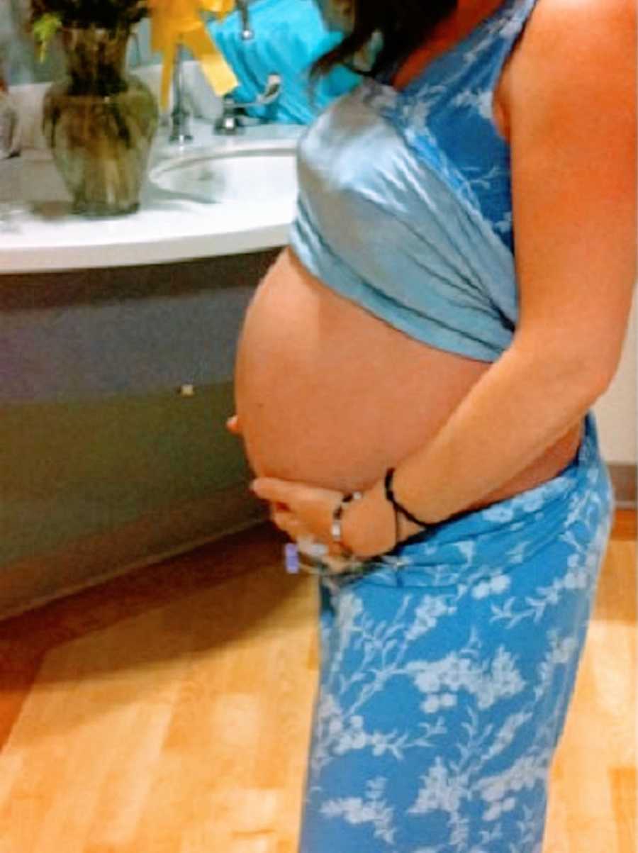 A pregnant woman's belly after the loss of one of her twins