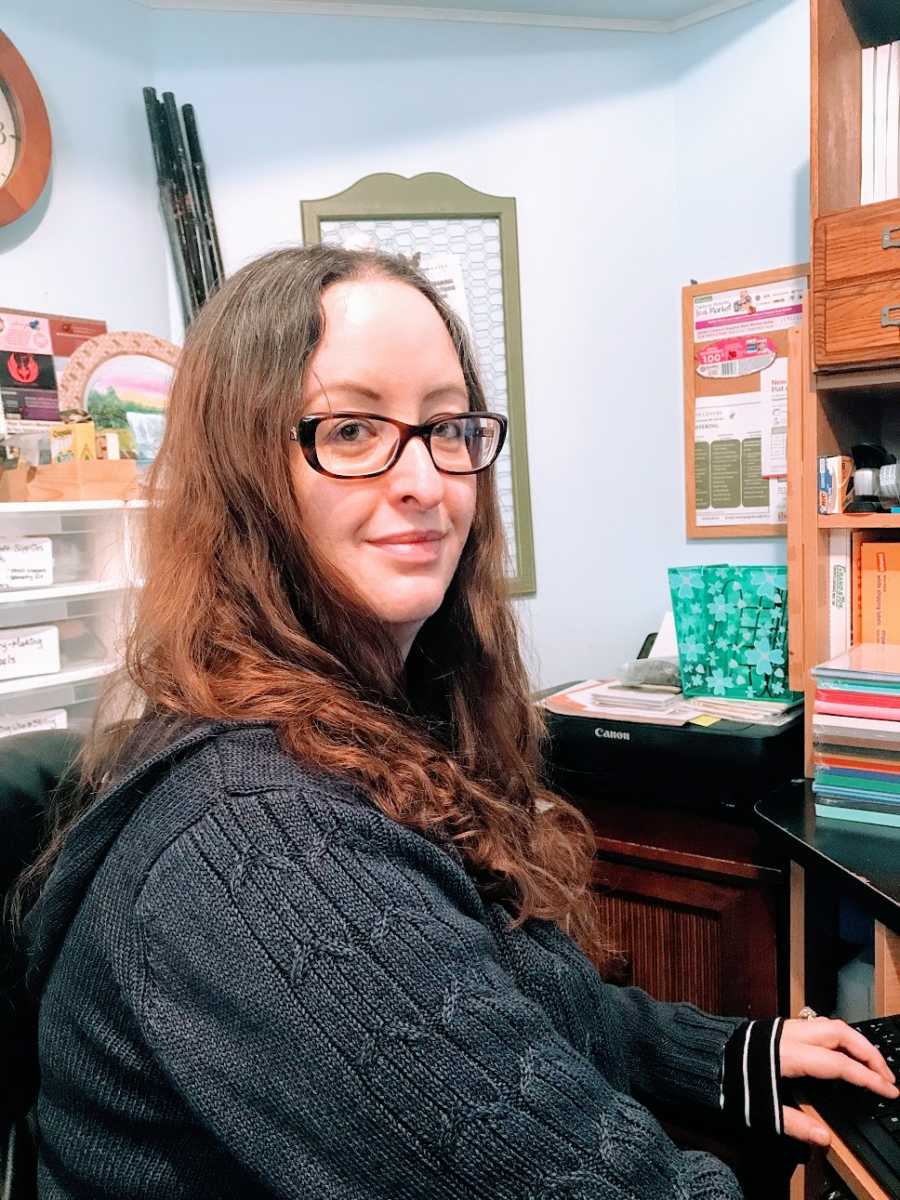 A woman working on writing in her office