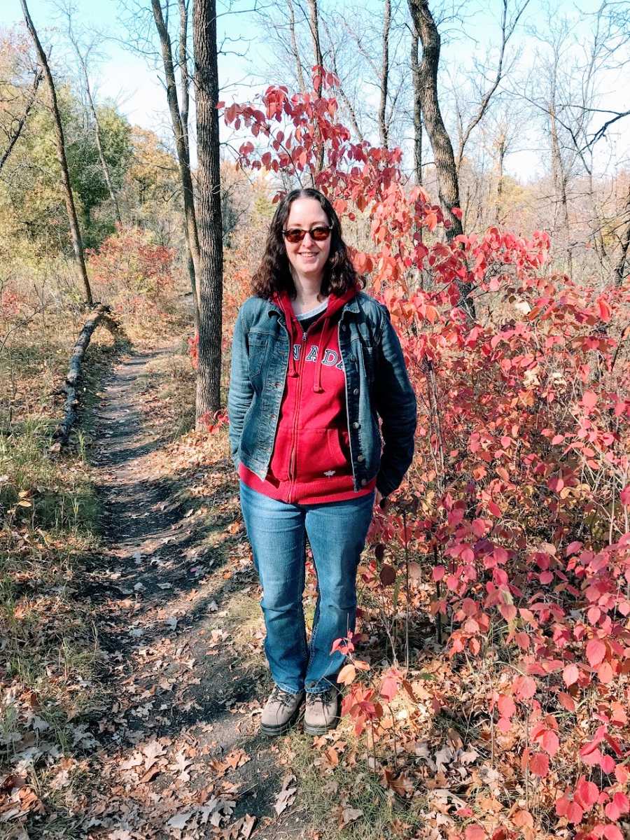 A woman standing in the woods