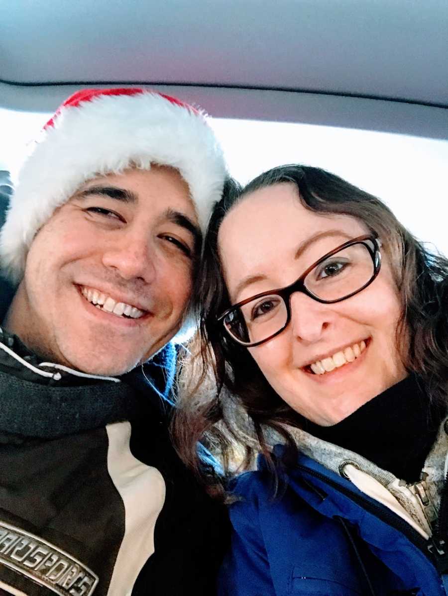 A woman and her partner who is wearing a Santa hat