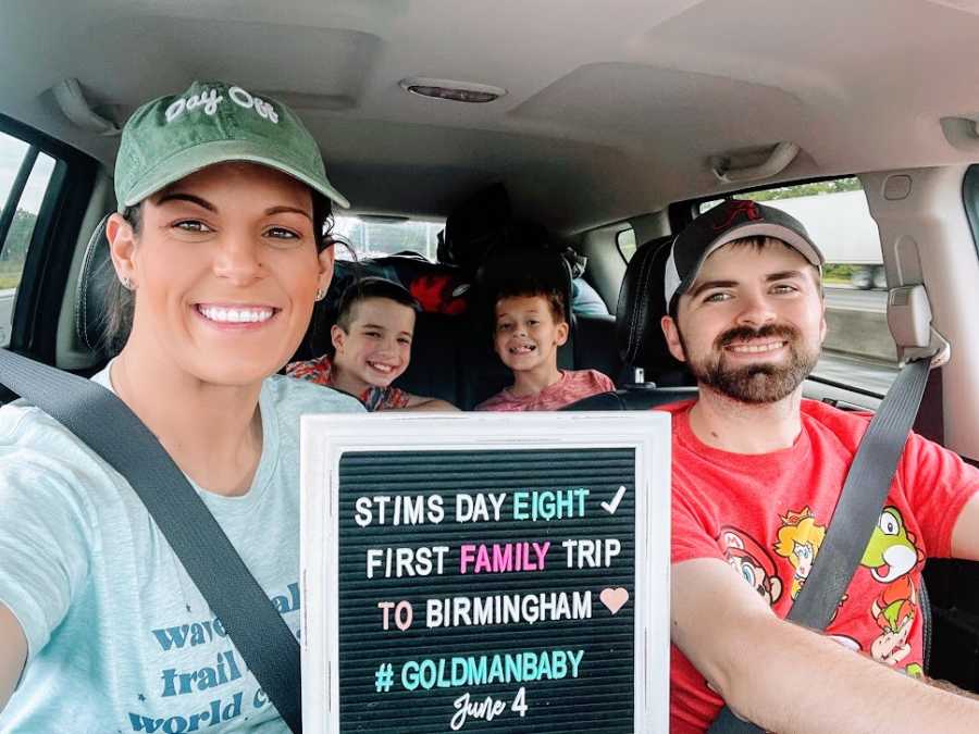 A family sits together in their car