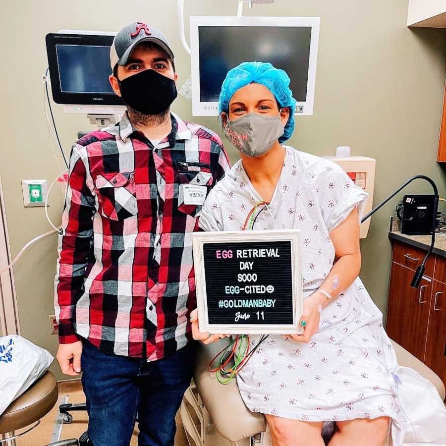 A woman and her husband wearing masks at a doctor's office