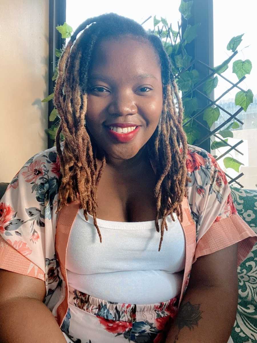 A woman wearing red lipstick and a floral shirt