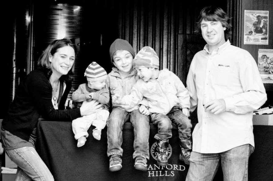 Parents stand on either side of their three children