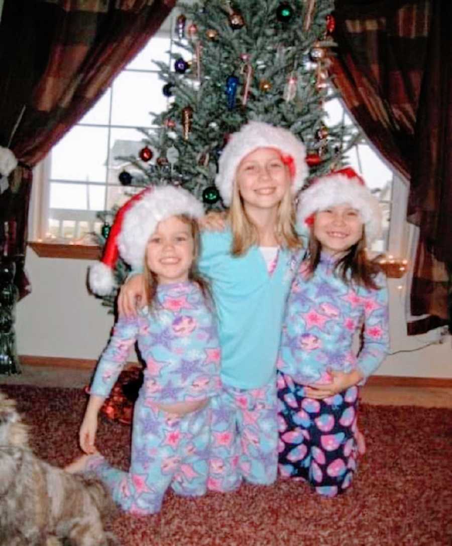 Three sisters stand together on Christmas