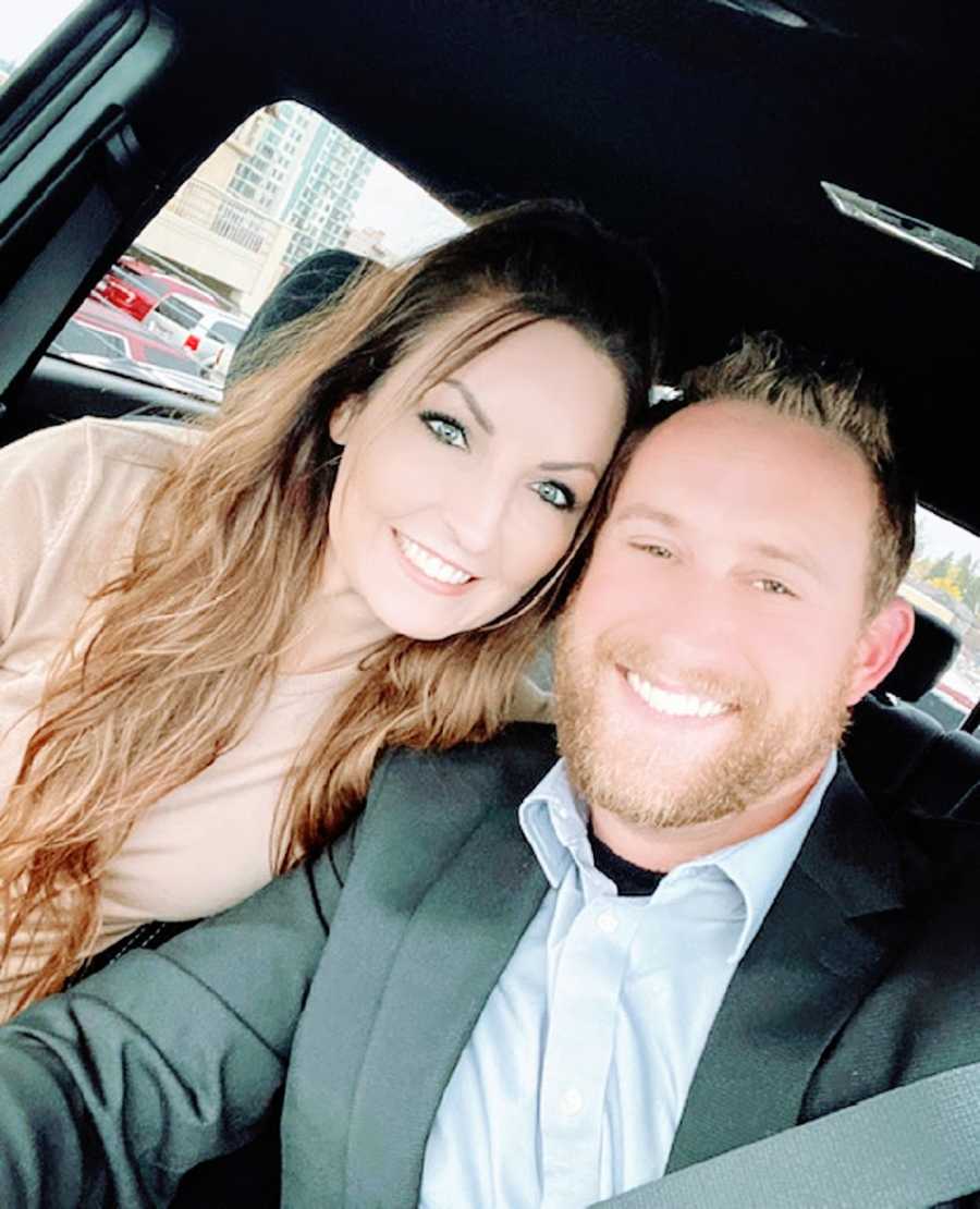 A woman and her husband sit together in a car