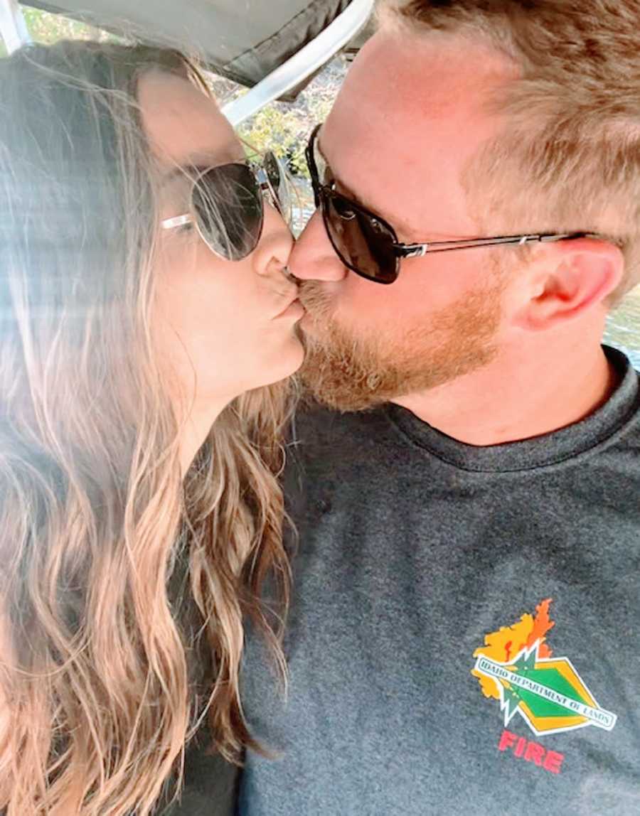 A couple kissing while wearing sunglasses