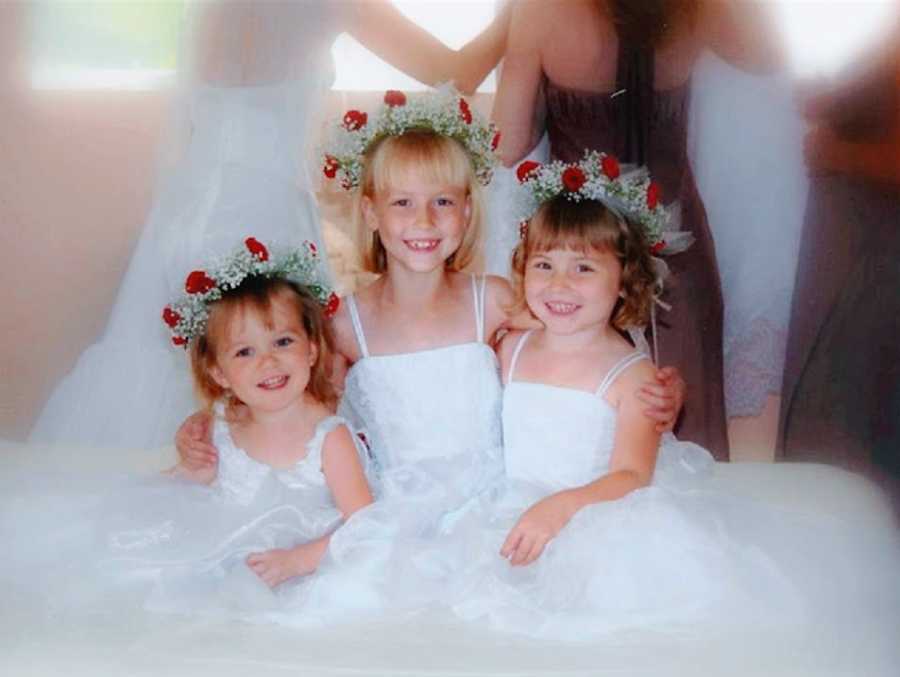 Three little girls wearing dresses for a wedding