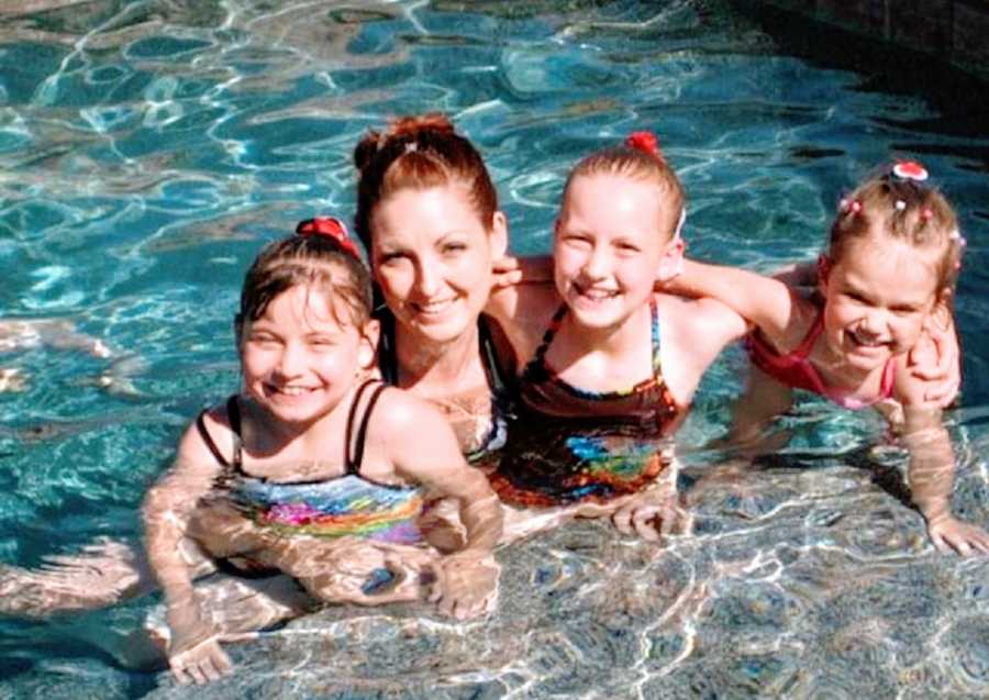 A mom with her daughters in a pool