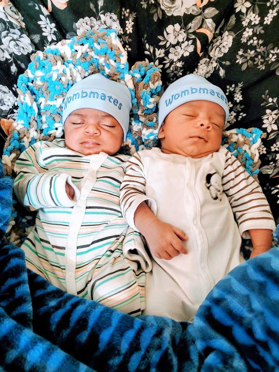 Twin baby brothers sleep next to each other