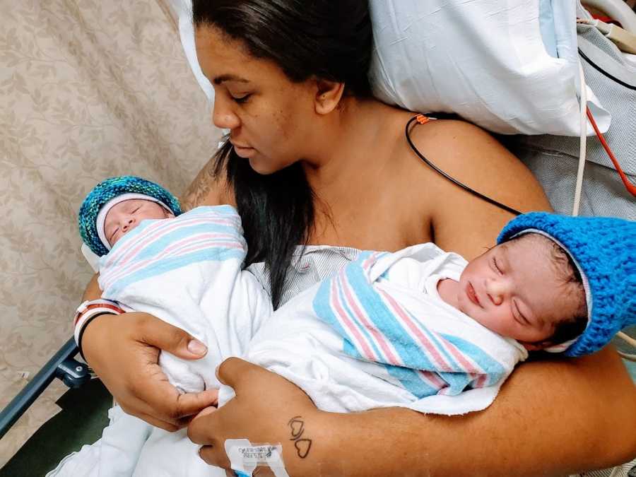 A mom holds her twins in the hospital