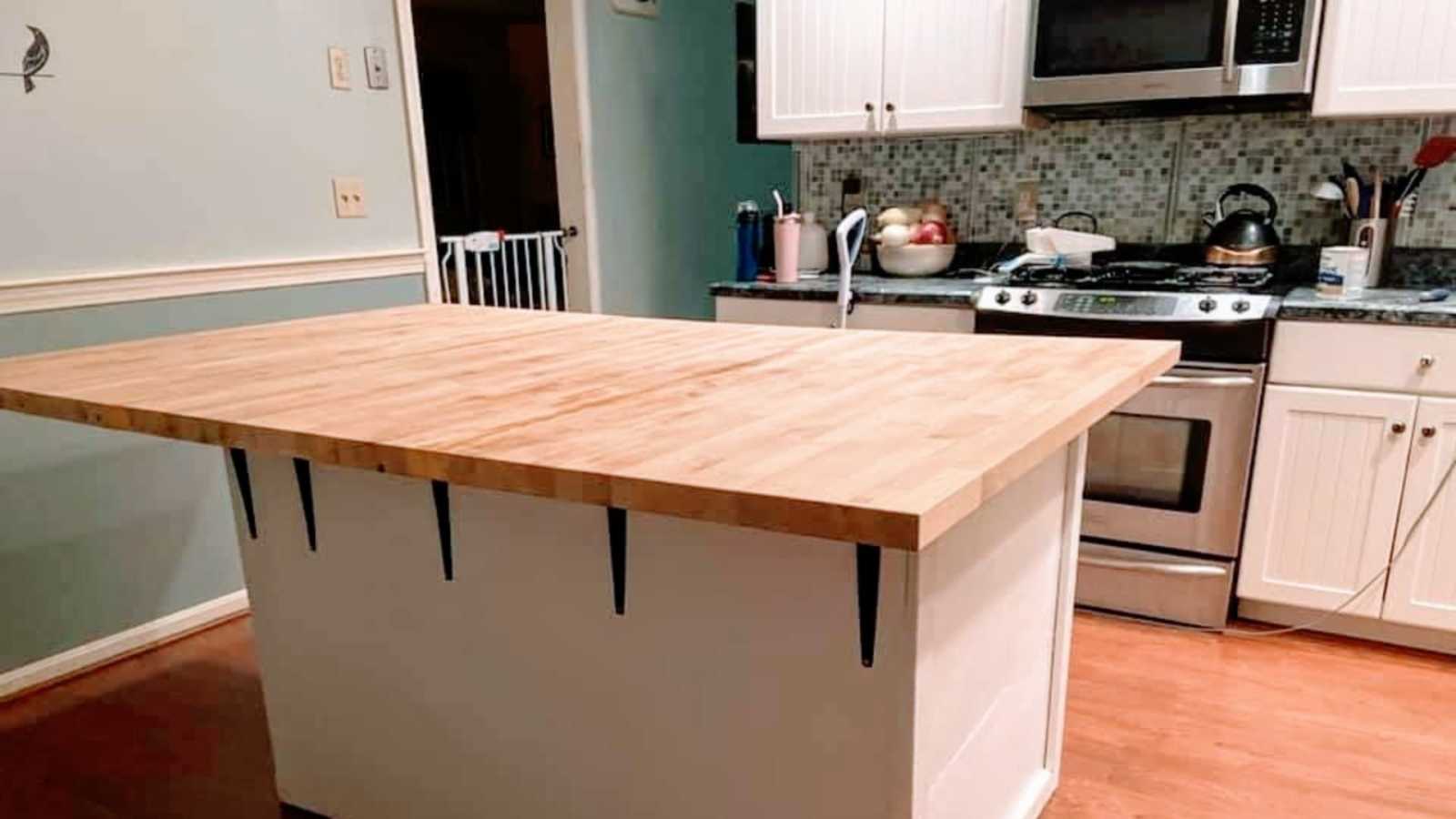 An empty kitchen with a large butcherblock island