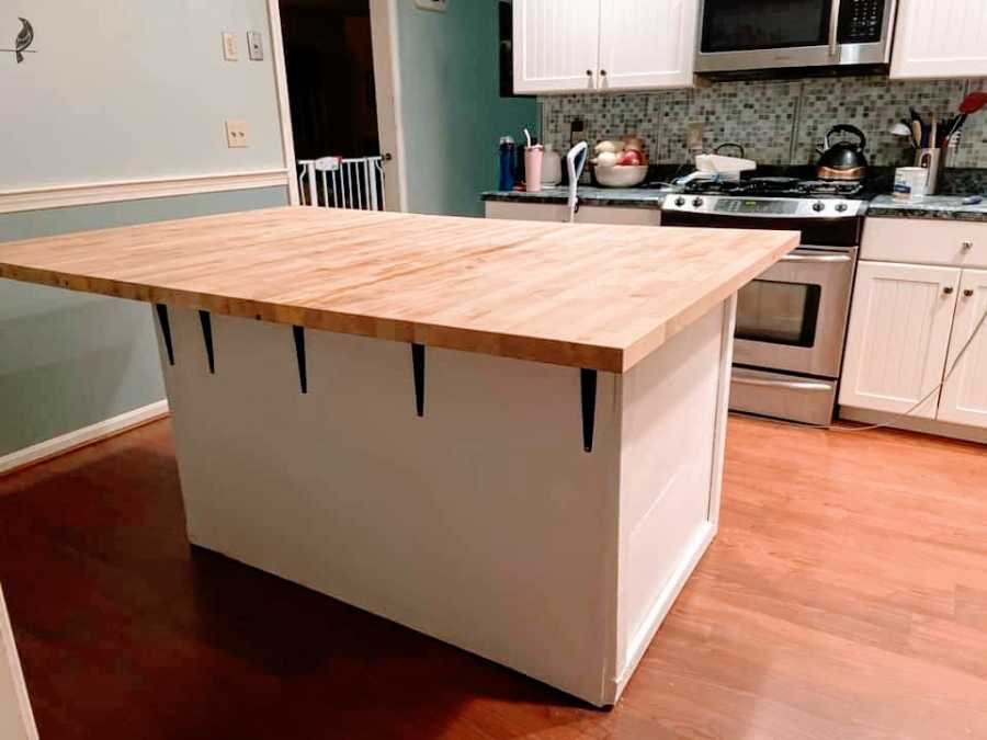 An empty kitchen with a large butcherblock island