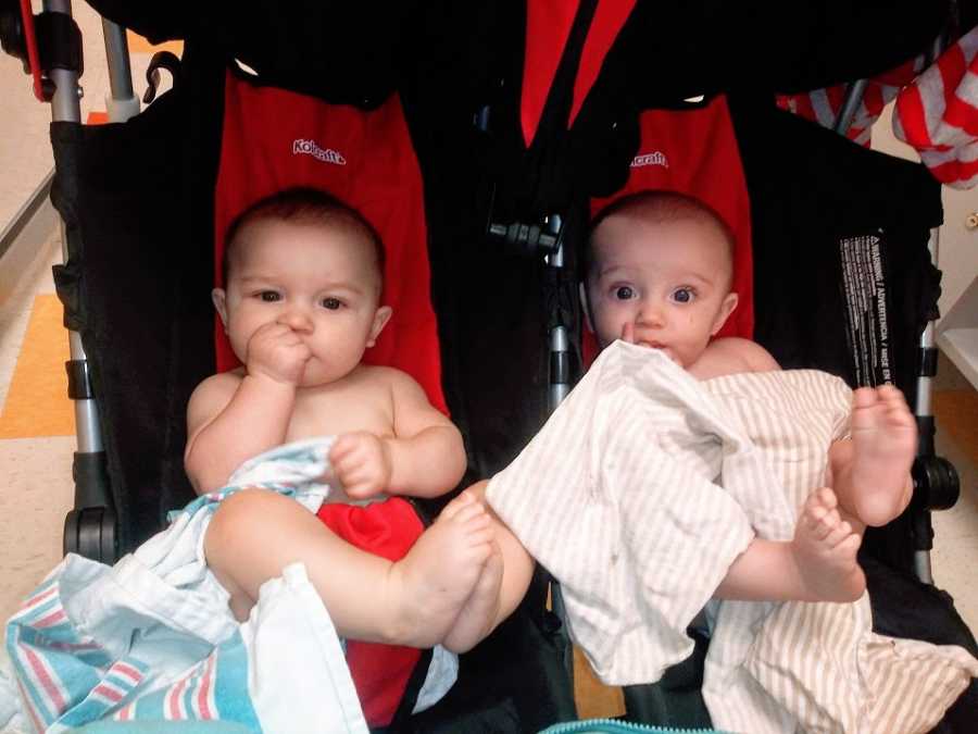 Twin boys sitting in a stroller 