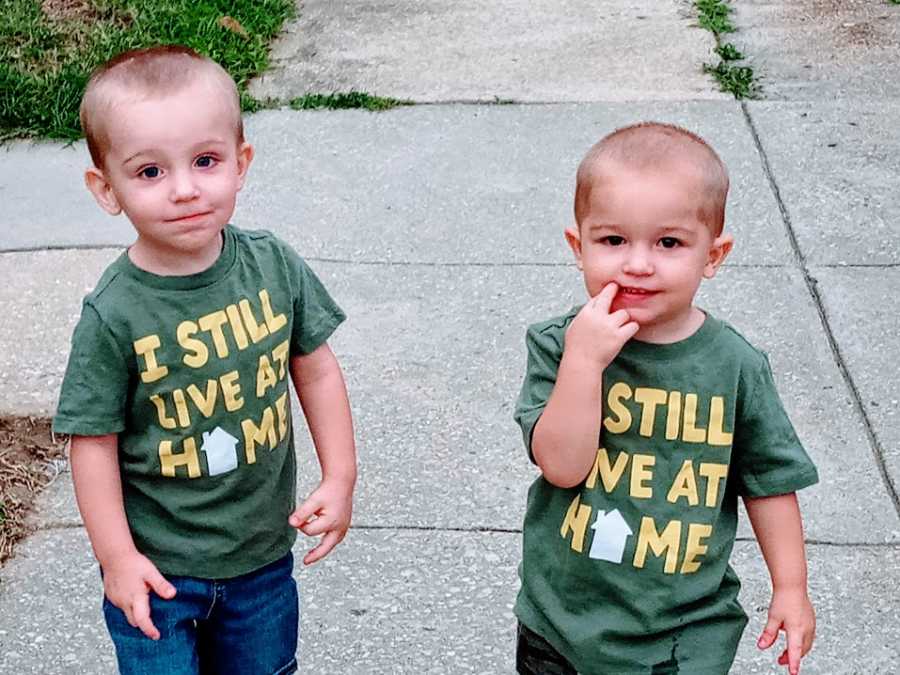 Little twin boys wearing matching green shirts