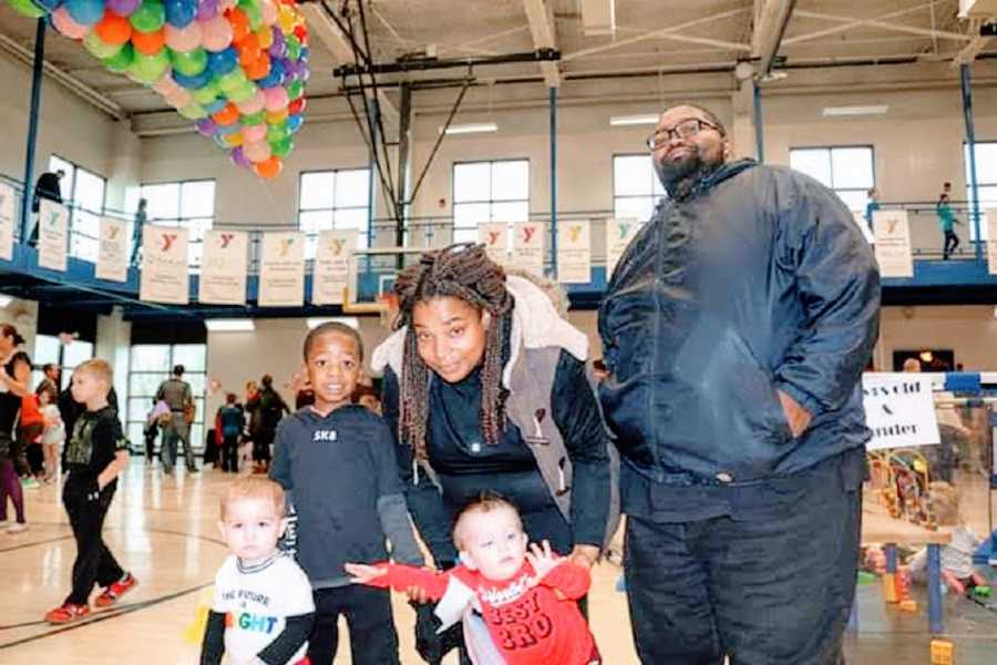 A mother with three of her children and her husband