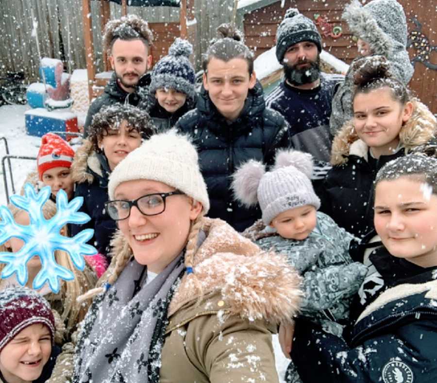 A family of 13 outside in the snow