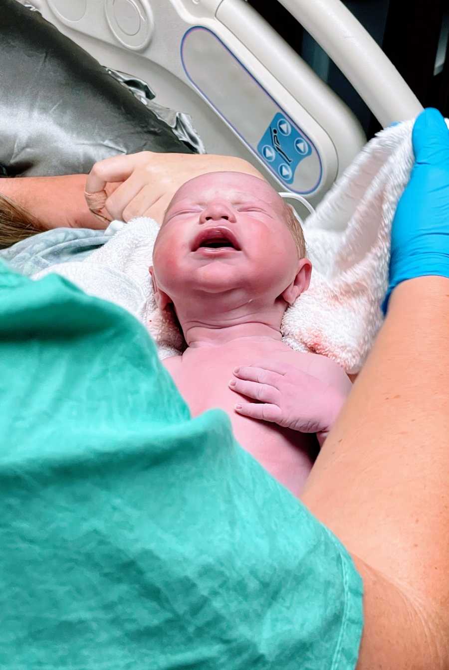 A baby boy is born from a gestational carrier in the hospital