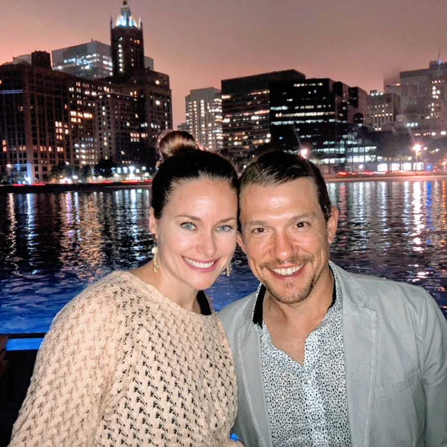 A woman and her husband stand together overlooking Chicago