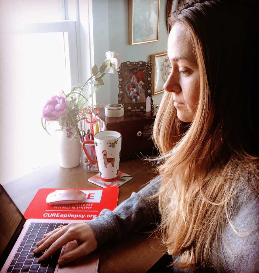 A woman types on her computer