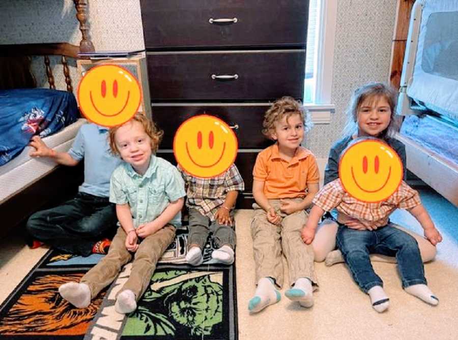 Children sit in their room with their foster siblings