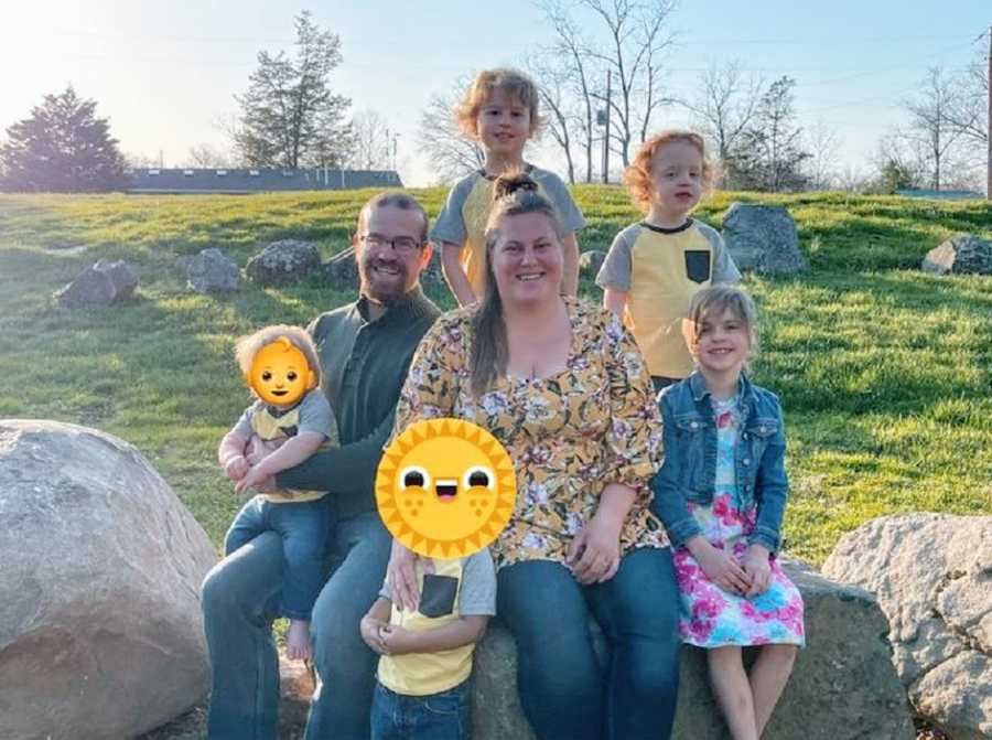 Foster parents sit with their three children and two foster kids