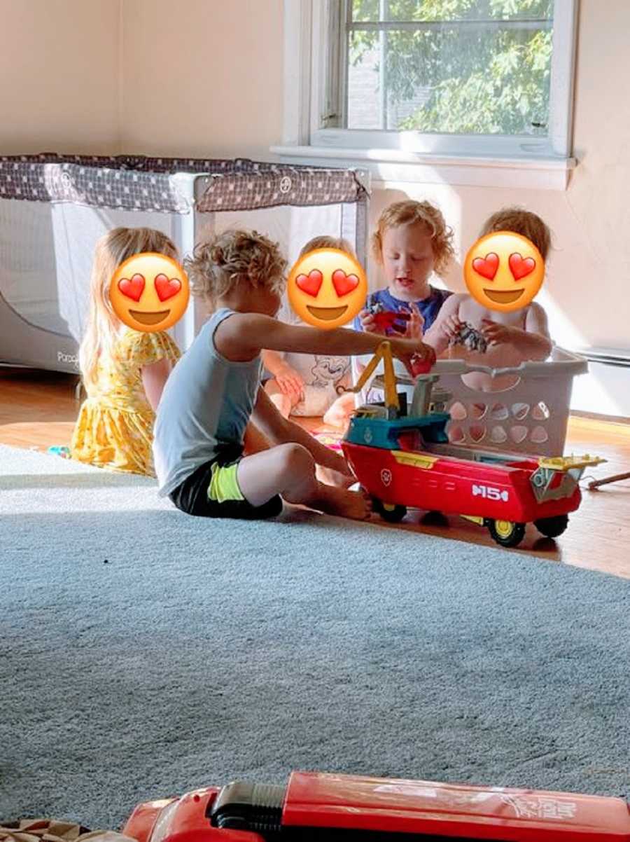 Boys play with their three foster siblings