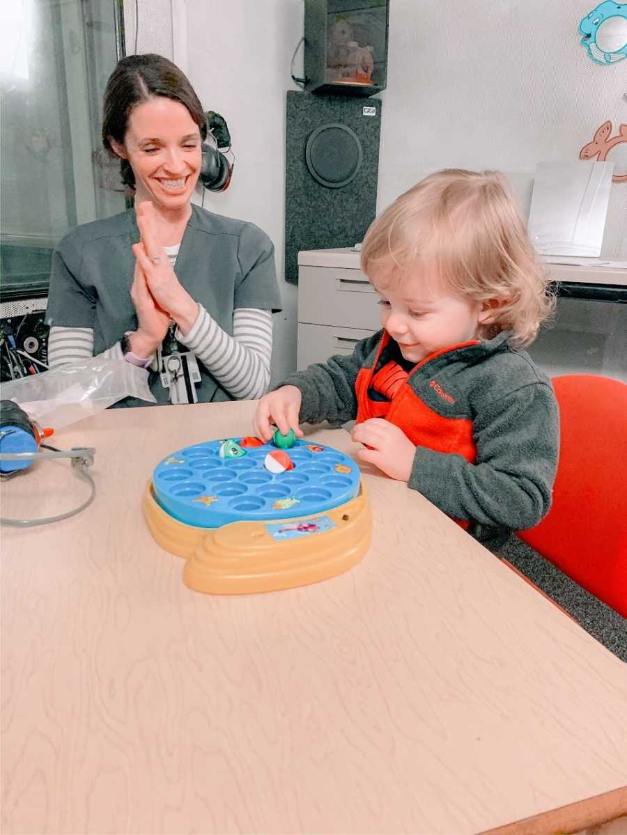 A little boy playing with a toy at a doctor's appointment