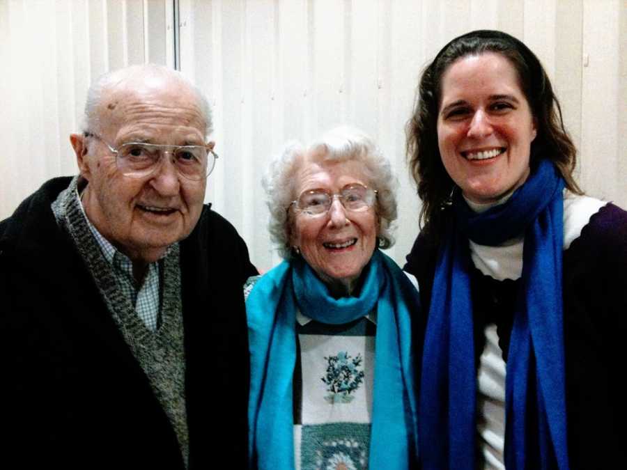 A woman stands with her grandparents