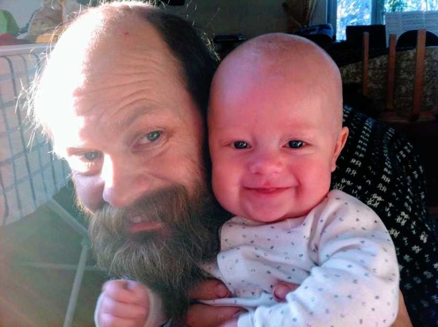 A man with a large beard and his baby